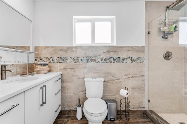 94825 Overseas Hwy, Key Largo, FL 33037 - full bathroom featuring a stall shower, tile walls, vanity, and wainscoting