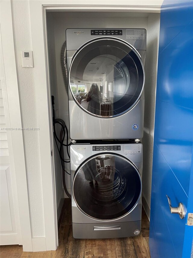 94825 Overseas Hwy, Key Largo, FL 33037 - washroom featuring stacked washer / drying machine and wood finished floors