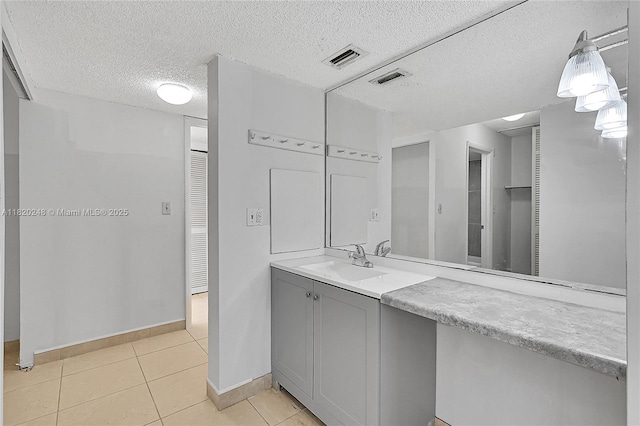 3680 Inverrary Dr Unit 1X, Lauderhill, FL 33319 - bathroom featuring tile patterned floors, a textured ceiling, and vanity