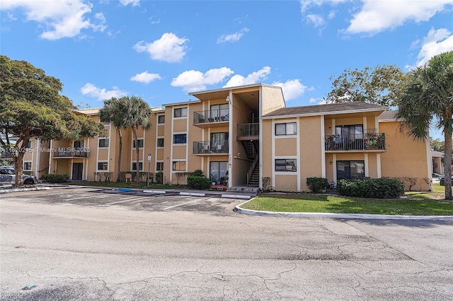 251 W Palm Cir W Unit 207, Pembroke Pines, FL 33025 - view of apartment building / complex featuring uncovered parking