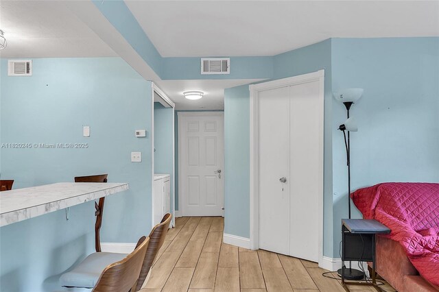 251 W Palm Cir W Unit 207, Pembroke Pines, FL 33025 - hallway with light wood finished floors and baseboards