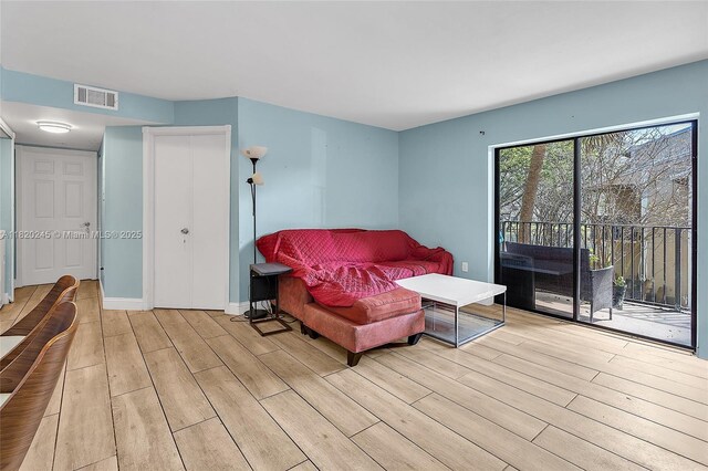 251 W Palm Cir W Unit 207, Pembroke Pines, FL 33025 - bedroom featuring light wood finished floors, access to exterior, and a closet