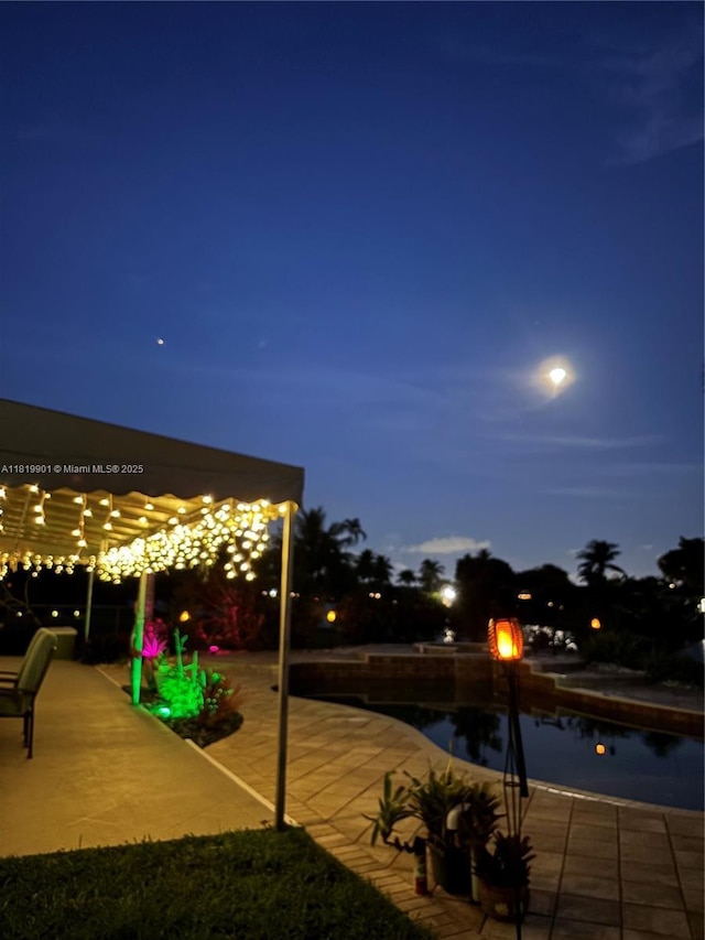 11520 NW 23rd St, Pembroke Pines, FL 33026 - pool at twilight with a pool and a patio