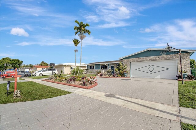11520 NW 23rd St, Pembroke Pines, FL 33026 - single story home with driveway, a garage, and stone siding