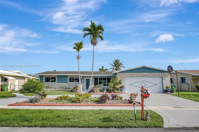 11520 NW 23rd St, Pembroke Pines, FL 33026 - ranch-style home featuring decorative driveway, stone siding, and a garage