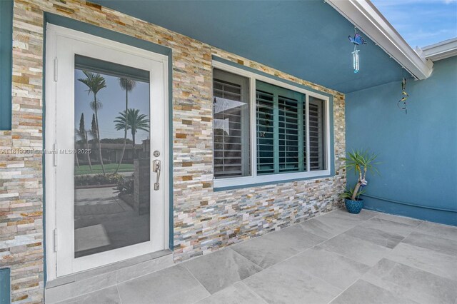 11520 NW 23rd St, Pembroke Pines, FL 33026 - doorway to property with stone siding and covered porch