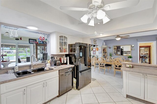 11520 NW 23rd St, Pembroke Pines, FL 33026 - kitchen featuring dishwasher, ceiling fan, glass insert cabinets, and a tray ceiling