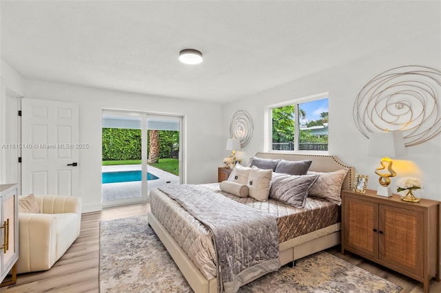 1365 SW 14th St, Boca Raton, FL 33486 - bedroom featuring access to outside, multiple windows, and light wood-style floors