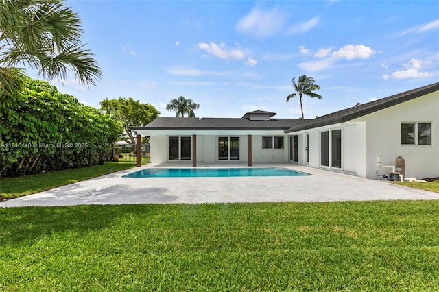 1365 SW 14th St, Boca Raton, FL 33486 - rear view of property with stucco siding, a patio, a lawn, and an outdoor pool