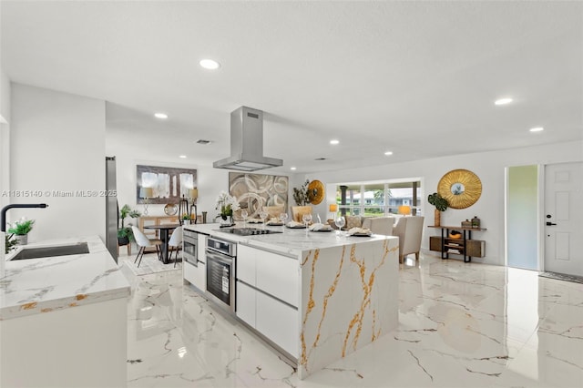 1365 SW 14th St, Boca Raton, FL 33486 - kitchen with range hood, stainless steel oven, recessed lighting, a center island, and light marble finish floors
