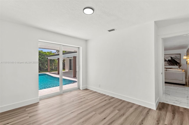 1365 SW 14th St, Boca Raton, FL 33486 - unfurnished room with wood finished floors and a textured ceiling