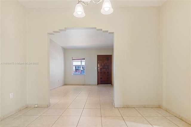 3685 SW 26th St, Miami, FL 33133 - tiled spare room with baseboards and a chandelier