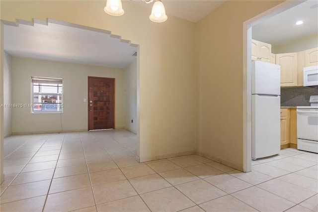 3685 SW 26th St, Miami, FL 33133 - kitchen with white appliances, light tile patterned floors, and dark countertops