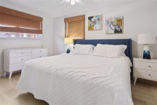 3685 SW 26th St, Miami, FL 33133 - bedroom with a textured ceiling, ceiling fan, and light wood-type flooring