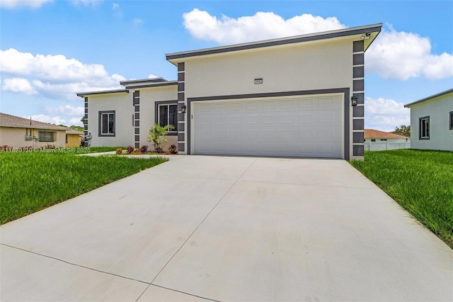 3512 2nd St W, Lehigh Acres, FL 33971 - view of front facade with stucco siding, a front lawn, driveway, and an attached garage