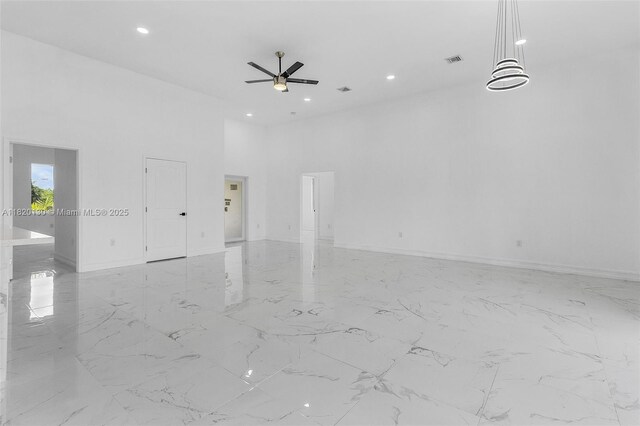 3512 2nd St W, Lehigh Acres, FL 33971 - spare room featuring recessed lighting, a ceiling fan, a high ceiling, and light marble finish floors