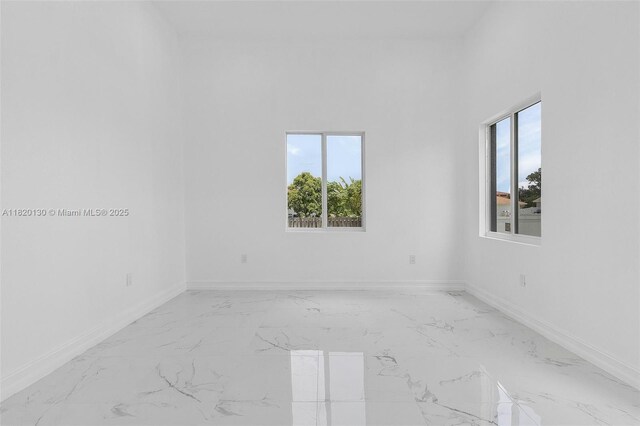 3512 2nd St W, Lehigh Acres, FL 33971 - unfurnished room featuring healthy amount of natural light and light marble finish floors