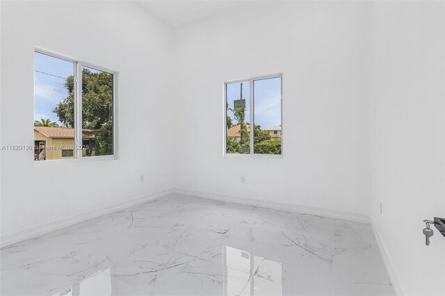 3512 2nd St W, Lehigh Acres, FL 33971 - empty room with baseboards and marble finish flooring