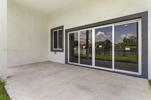 3512 2nd St W, Lehigh Acres, FL 33971 - view of exterior entry with a patio and stucco siding