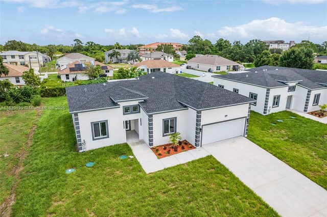 3512 2nd St W, Lehigh Acres, FL 33971 - view of front of home featuring stucco siding, a residential view, a garage, and roof with shingles