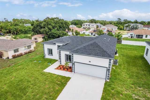 3512 2nd St W, Lehigh Acres, FL 33971 - view of front of house with a shingled roof, stucco siding, an attached garage, and concrete driveway