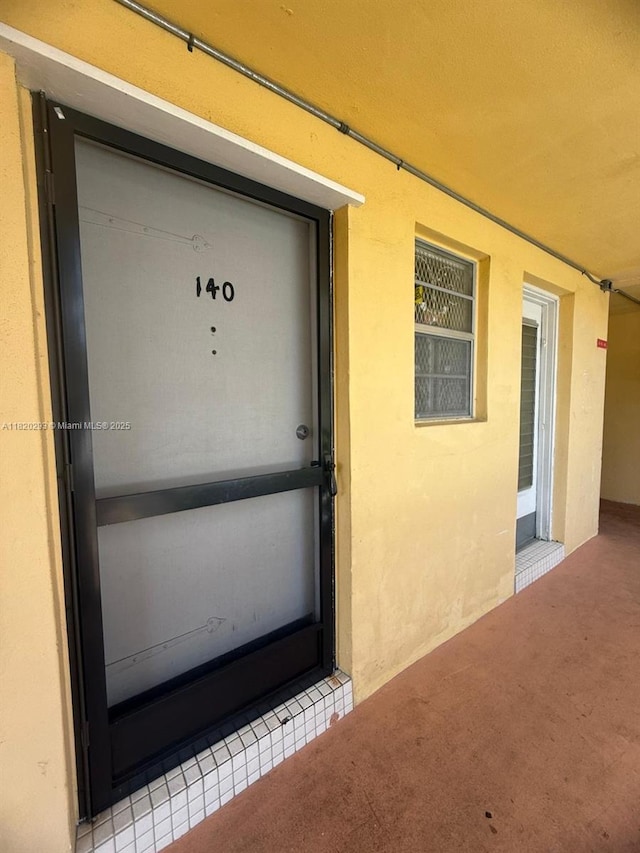 1540 NE 191st St Unit 140, Miami, FL 33179 - view of exterior entry with stucco siding