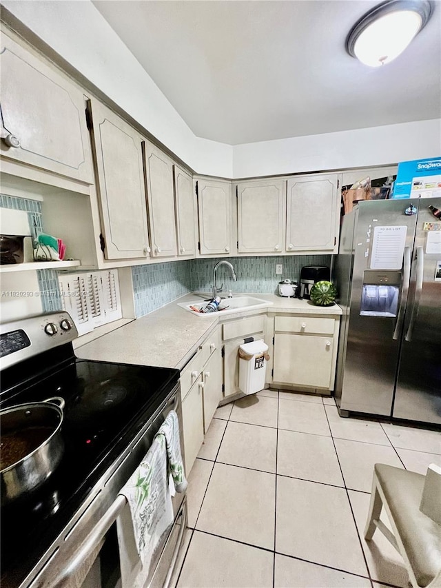 1540 NE 191st St Unit 140, Miami, FL 33179 - kitchen with stainless steel appliances, light countertops, and light tile patterned floors