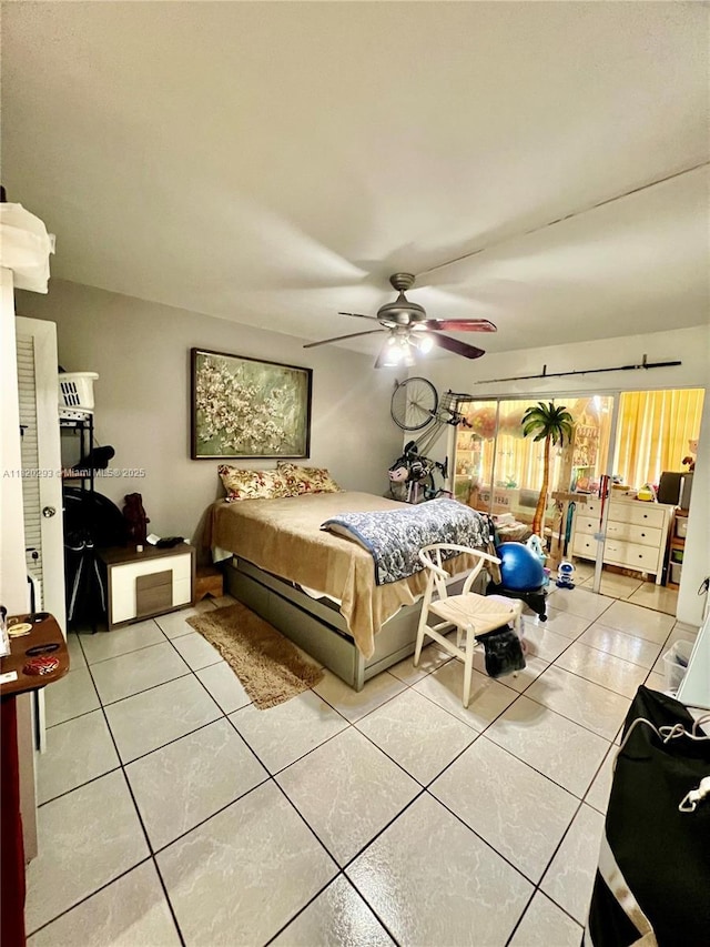 1540 NE 191st St Unit 140, Miami, FL 33179 - bedroom with light tile patterned floors and a ceiling fan