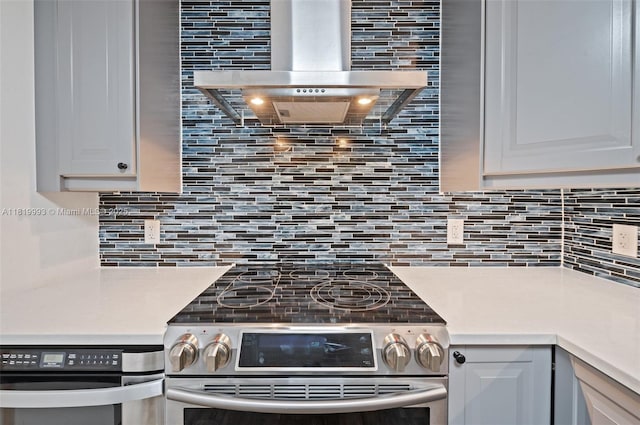 10185 Collins Ave Unit 1508, Bal Harbour, FL 33154 - kitchen featuring stainless steel electric range, range hood, tasteful backsplash, light countertops, and oven