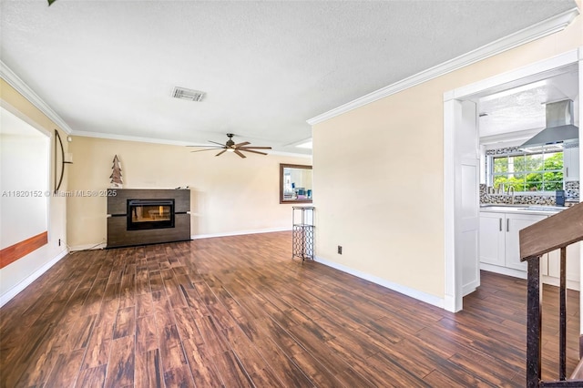 16530 Royal Poinciana Ct, Weston, FL 33326 - unfurnished living room featuring dark wood-style floors, crown molding, ceiling fan, a glass covered fireplace, and a textured ceiling