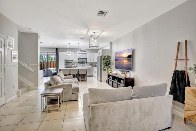 18410 NW 91st Ct, Hialeah, FL 33018 - living area featuring light tile patterned floors, a chandelier, and stairway