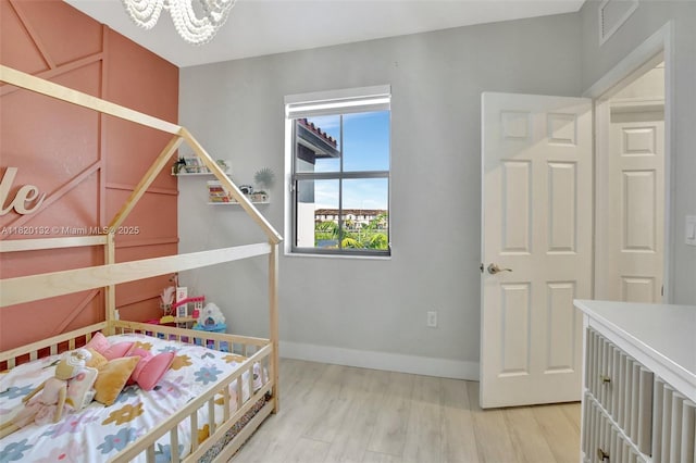 18410 NW 91st Ct, Hialeah, FL 33018 - bedroom featuring light wood-style floors and a chandelier