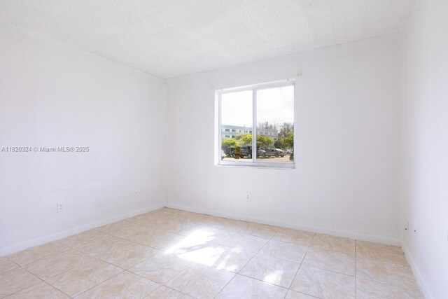 14850 Naranja Lakes Blvd Unit B1B, Homestead, FL 33032 - unfurnished room featuring a textured ceiling and light tile patterned floors