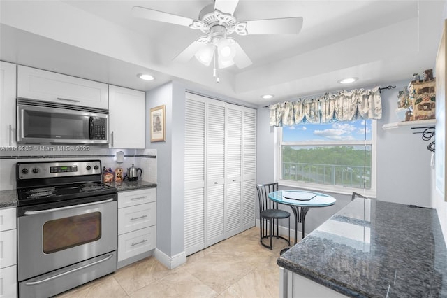 7608 NW 18th St Unit 405, Margate, FL 33063 - kitchen with stainless steel appliances, white cabinetry, recessed lighting, dark stone counters, and ceiling fan