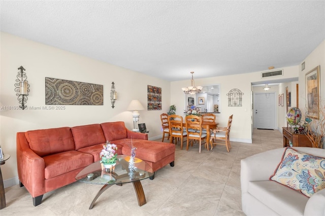 7608 NW 18th St Unit 405, Margate, FL 33063 - living room featuring a chandelier, a textured ceiling, and light tile patterned floors