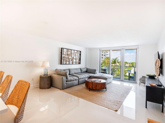 5701 Collins Ave Unit 307, Miami Beach, FL 33140 - tiled living area with floor to ceiling windows