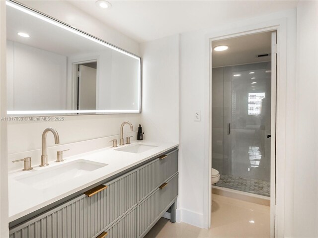 5701 Collins Ave Unit 307, Miami Beach, FL 33140 - full bathroom with double vanity, a shower stall, and recessed lighting