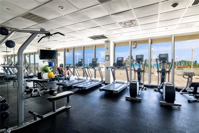 5701 Collins Ave Unit 307, Miami Beach, FL 33140 - workout area with floor to ceiling windows and a drop ceiling