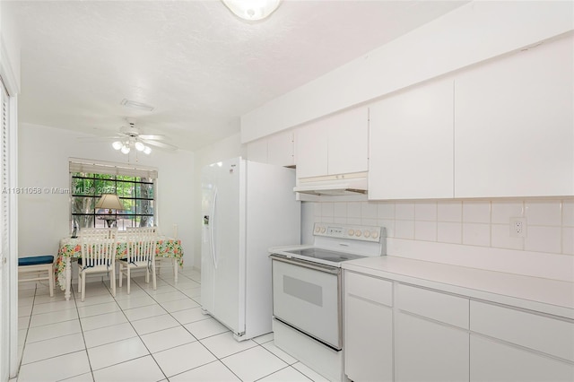 8701 SW 80th St, Miami, FL 33173 - kitchen featuring white appliances, under cabinet range hood, light countertops, light tile patterned flooring, and tasteful backsplash