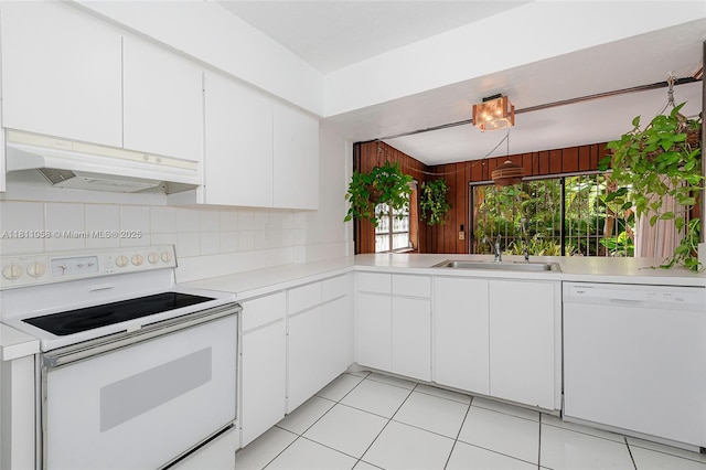 8701 SW 80th St, Miami, FL 33173 - kitchen with white appliances, custom exhaust hood, light countertops, decorative backsplash, and white cabinets