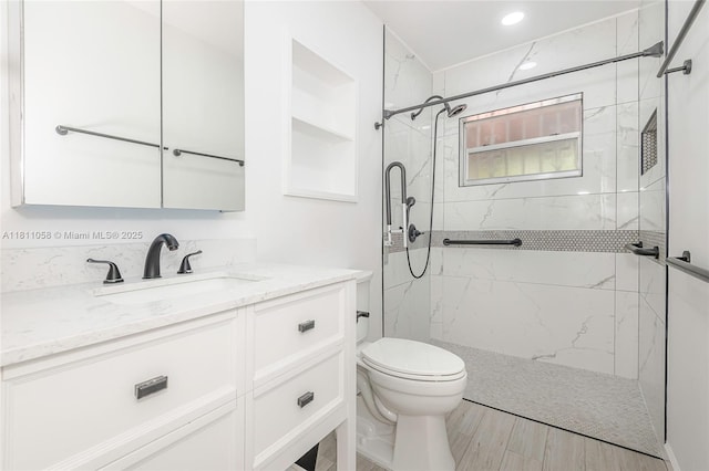 8701 SW 80th St, Miami, FL 33173 - bathroom featuring vanity, a marble finish shower, recessed lighting, and wood finished floors