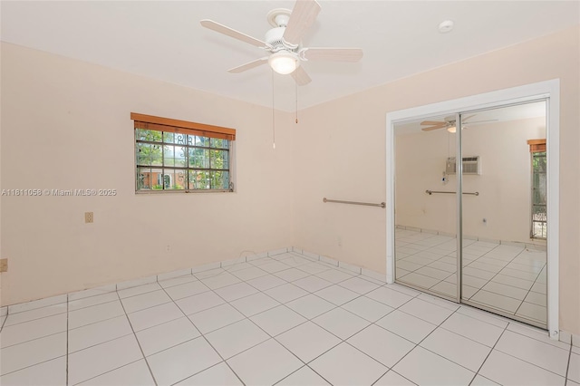 8701 SW 80th St, Miami, FL 33173 - spare room featuring ceiling fan, a wall mounted air conditioner, light tile patterned floors, and a smoke detector