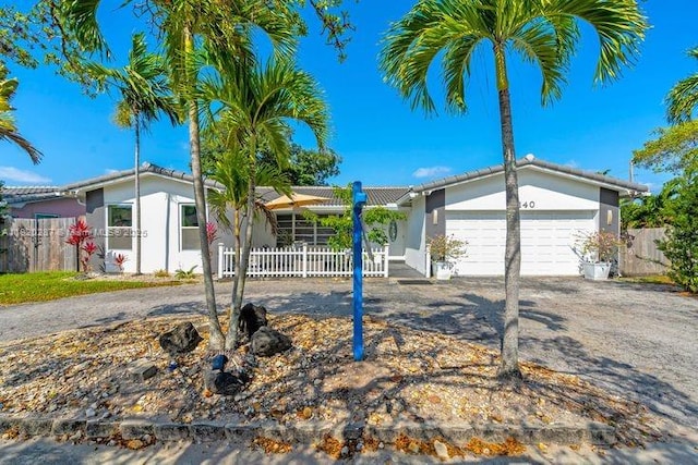 4140 N 36th Ave, Hollywood, FL 33021 - ranch-style home featuring stucco siding, an attached garage, and driveway