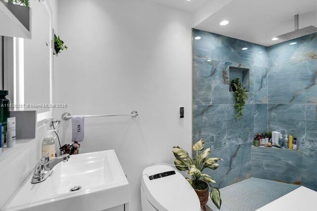 4140 N 36th Ave, Hollywood, FL 33021 - bathroom featuring tile walls, double vanity, a marble finish shower, recessed lighting, and tile patterned flooring