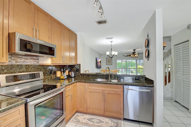 20865 NW 3rd Ln, Pembroke Pines, FL 33029 - kitchen featuring stainless steel appliances, light tile patterned flooring, backsplash, a chandelier, and dark stone countertops