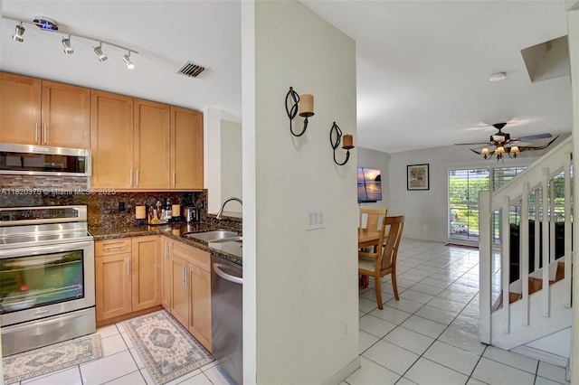 20865 NW 3rd Ln, Pembroke Pines, FL 33029 - kitchen with stainless steel appliances, light tile patterned floors, backsplash, and dark stone counters