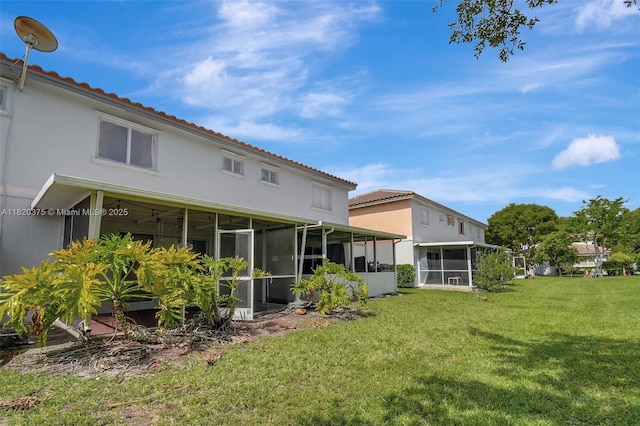 20865 NW 3rd Ln, Pembroke Pines, FL 33029 - back of house featuring a sunroom, a yard, and stucco siding