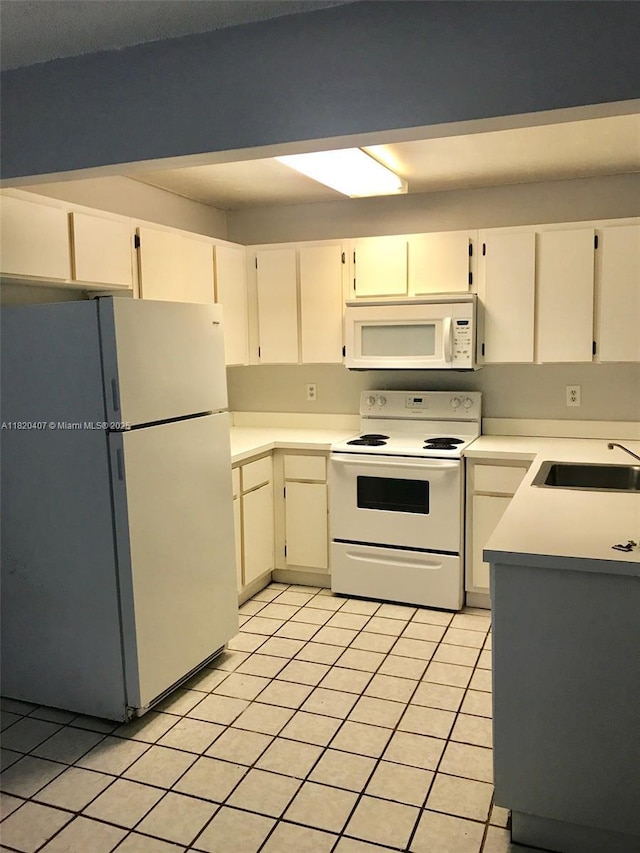 9810 Hammocks Blvd Unit 202, Miami, FL 33196 - kitchen with white appliances, light tile patterned floors, and light countertops