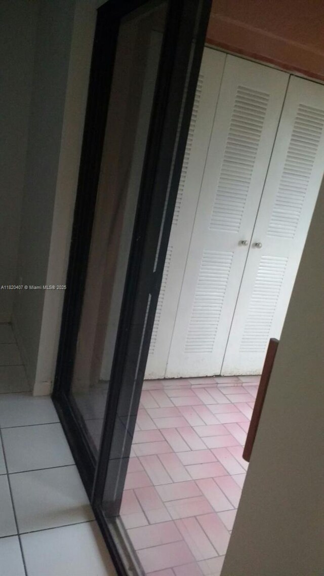 9810 Hammocks Blvd Unit 202, Miami, FL 33196 - corridor featuring light tile patterned floors