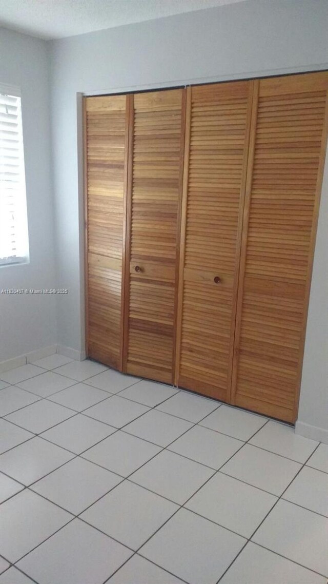9810 Hammocks Blvd Unit 202, Miami, FL 33196 - unfurnished bedroom with a closet and light tile patterned flooring